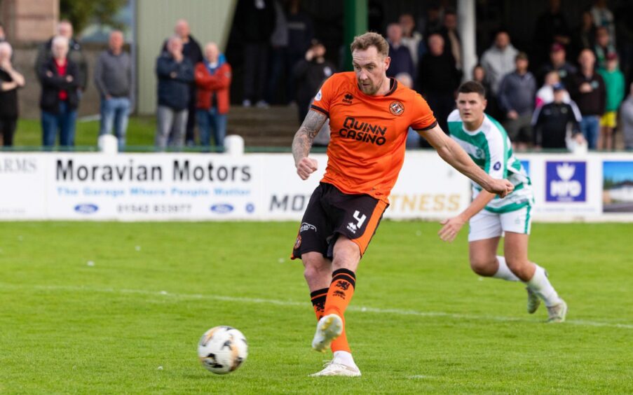 Dundee United's Kevin Holt makes no mistake from the penalty spot.