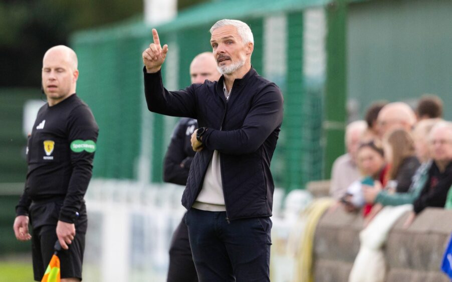 Dundee United Jim Goodwin looks on as his side claim victory