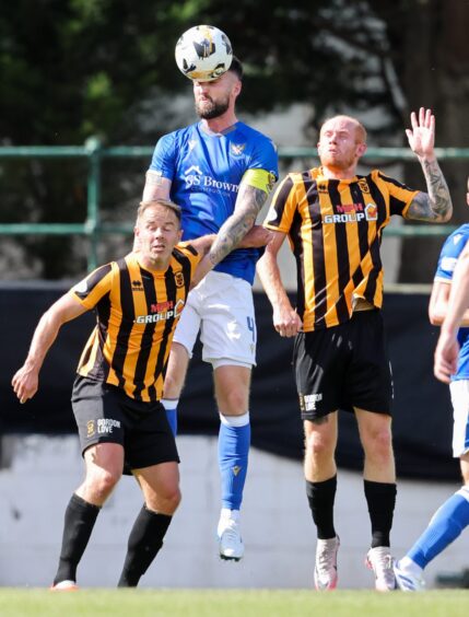 Kyle Cameron wins a header against East Fife. 