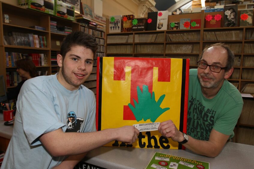 Kieron Gardiner from Lochee gets his ticket from Alastair Brodie at a Dundee music store