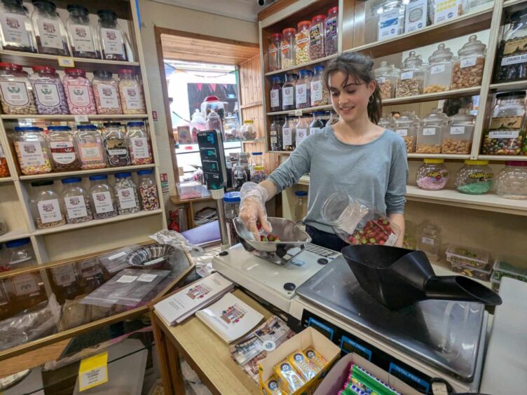 Star Rock Shop worker Rosie Chamberlain weighs some sweets.