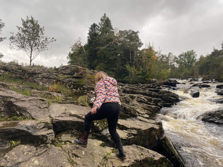 Rebecca exploring the Falls of Dochart during a rainy day in summer 2023.