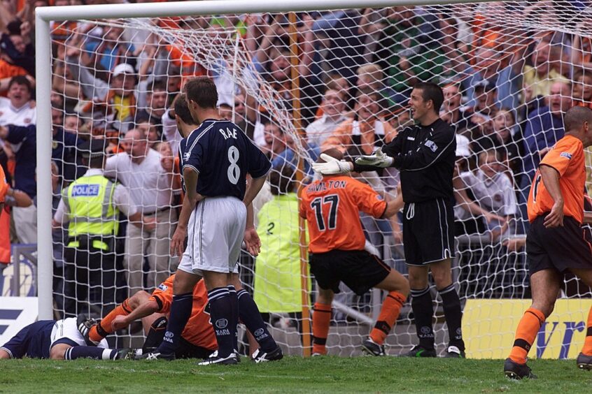 Dundee United's Jim Hamilton scrambles home in dramatic fashion.