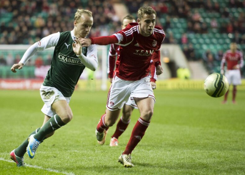 Clark Robertson in action for Aberdeen in 2013, getting to grips with Hibs' 