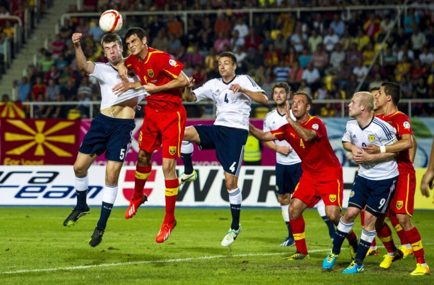 David Babunski, No.8, challenges Grant Hanley during a Scotland visit to Skopje