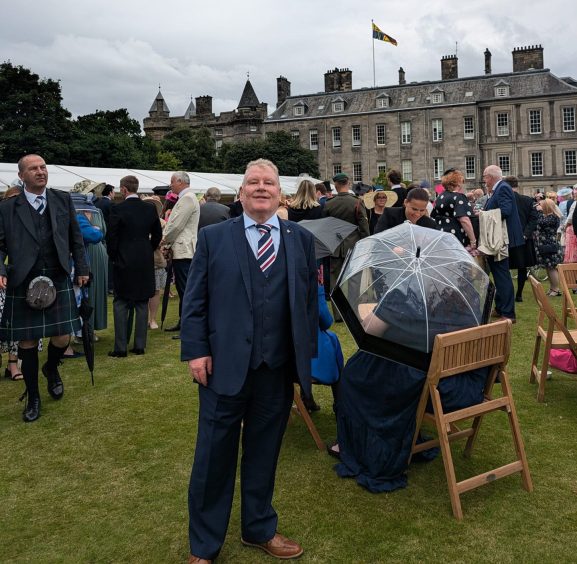 Arthur Rodgie in smart suit at royal garden party in Edinburgh
