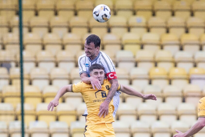 Dunfermline Athletic FC skipper Kyle Benedictus rises high to head clear against Livi.