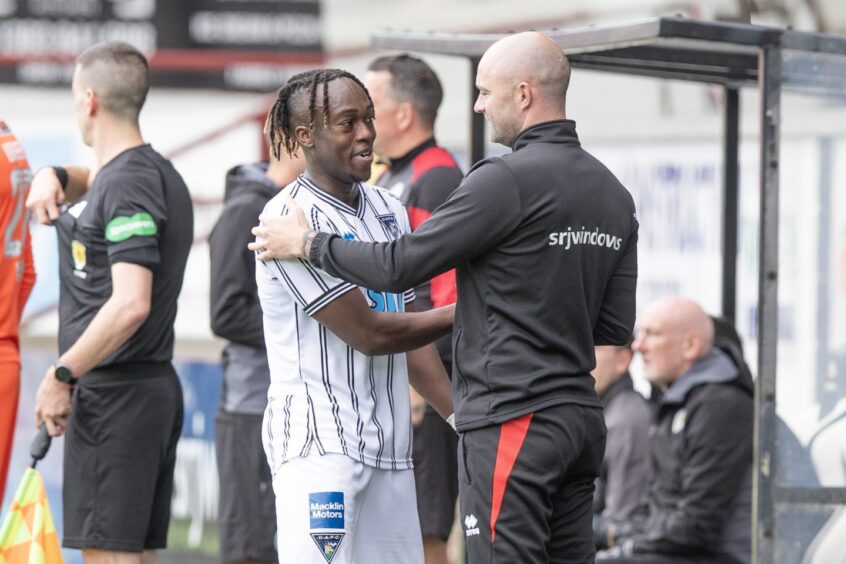 Ewan Otoo and Dunfermline manager James McPake shake hands.