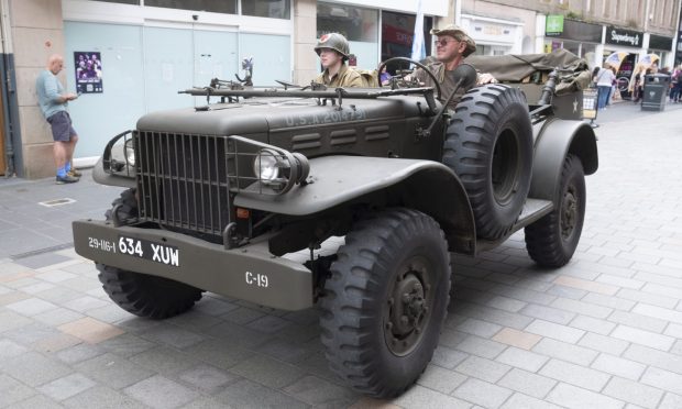 Reenactors driving down Perth's High Street at the 2023 event.