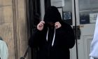 Married Calum Watson hid his face as he left Perth Sheriff Court