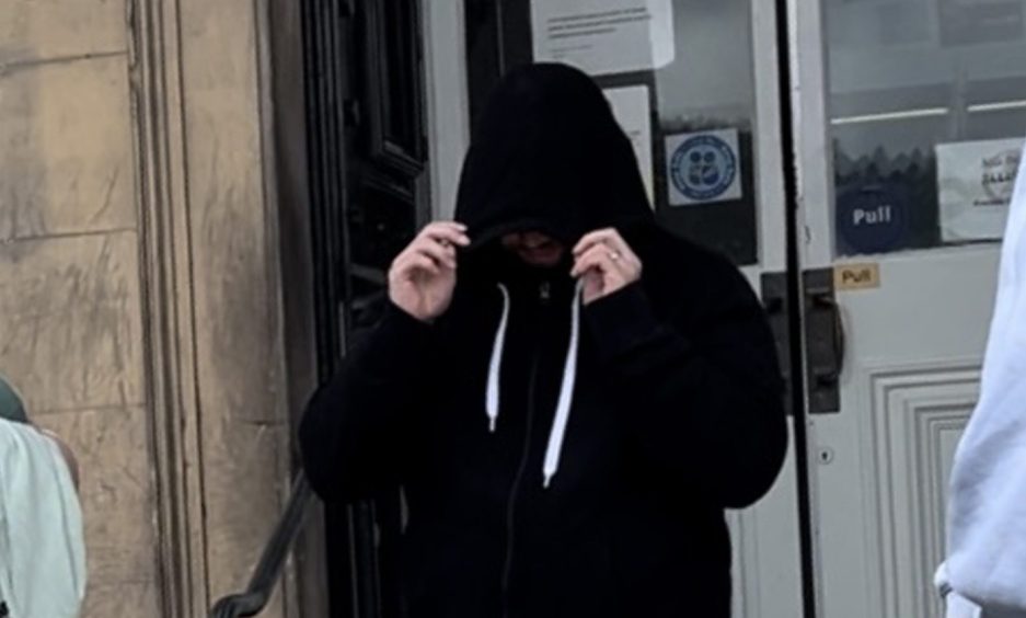 Married Calum Watson hid his face as he left Perth Sheriff Court.