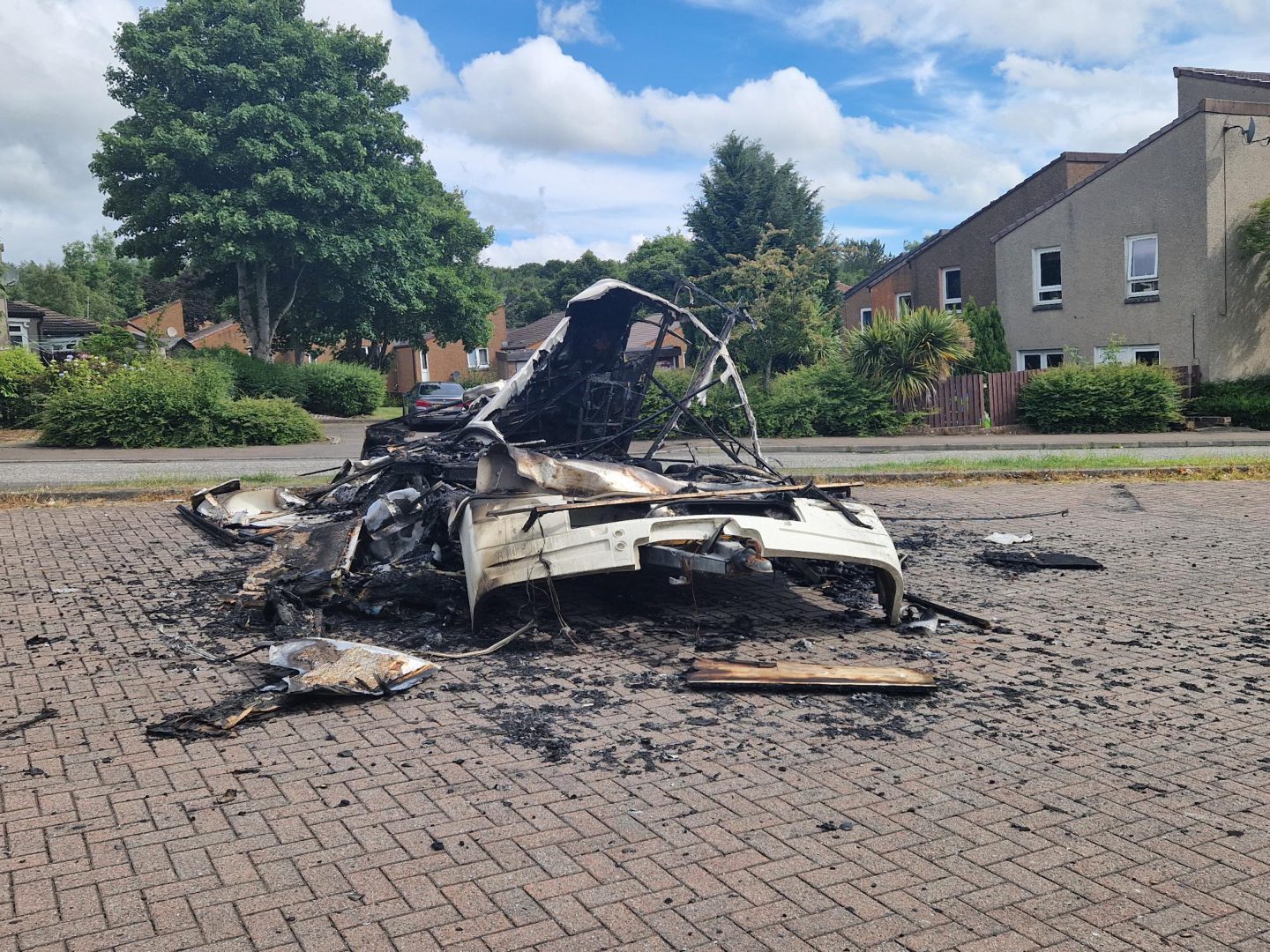 The remains of a caravan set alight in the car park of Collydean Local store in Piper Drive, Glenrothes