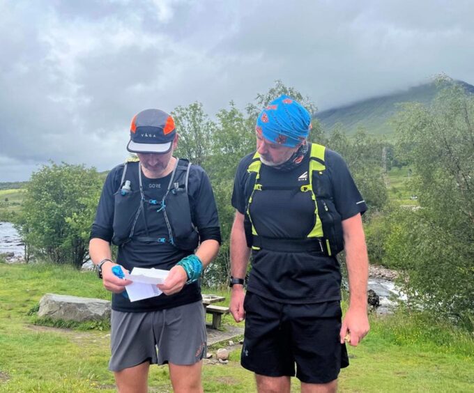 Kinghorn dad Craig pictured at the West Highland Way Race opening the letter from wife Nichola.