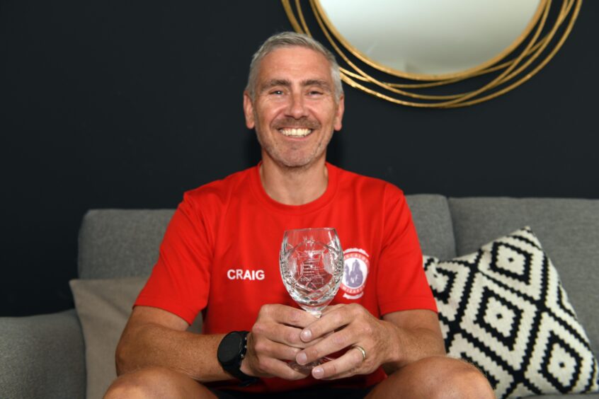 Kinghorn runner Craig pictured with the crystal goblet he got for completing the West Highland Way Race