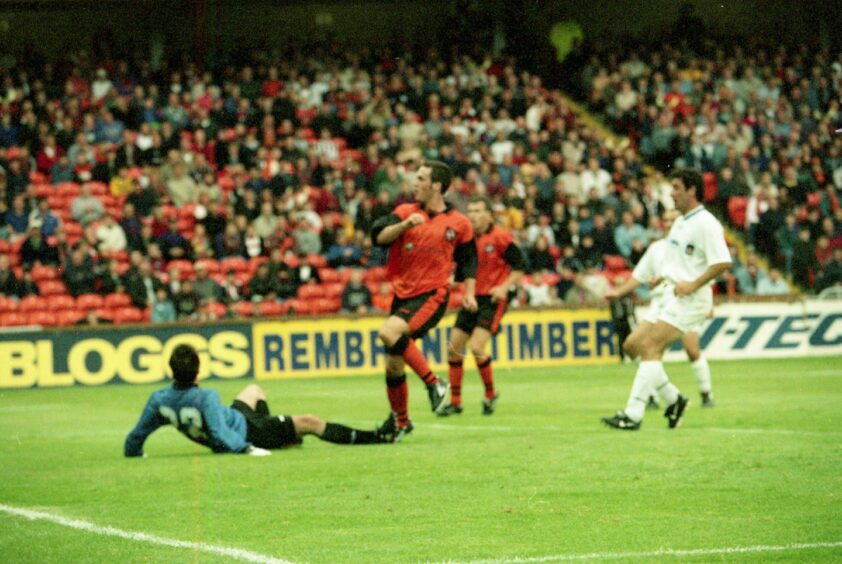 The goalie lies on the ground as Dundee United forward Robbie Winters gets the second goal 