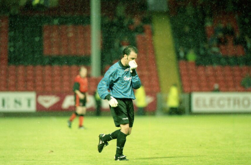 the Principat goalkeeper runs off the Tannadice pitch after the game