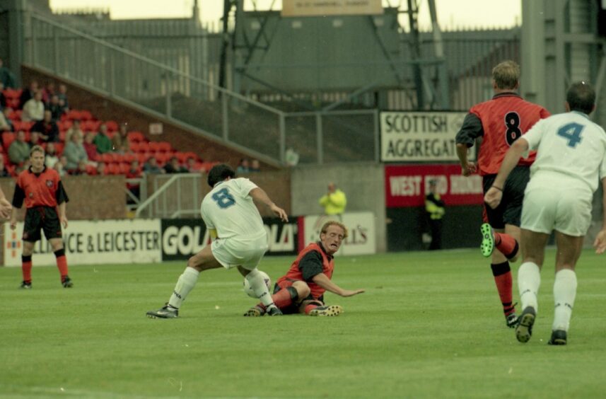 Dundee United midfielder Dave Bowman puts in a sliding tackle against Principat at Tannadice. 