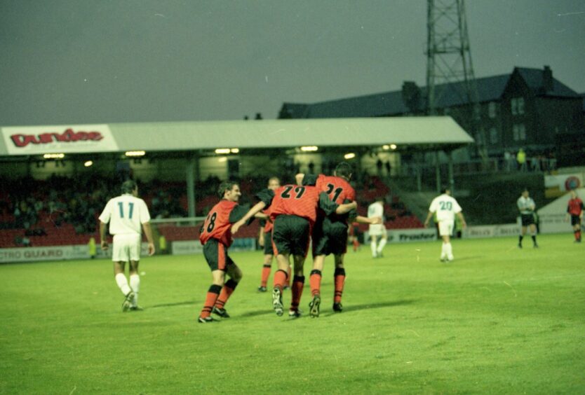 United players celebrate on the pitch after another goal against Principat