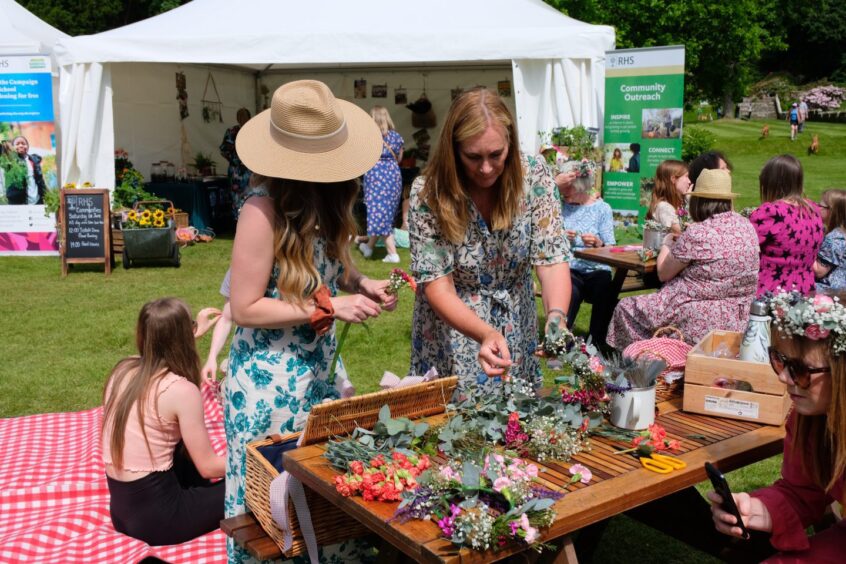 Women at dried flower stall at Scone Palace garden fair