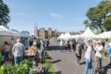 People walking around exhibits in grounds of Scone Palace