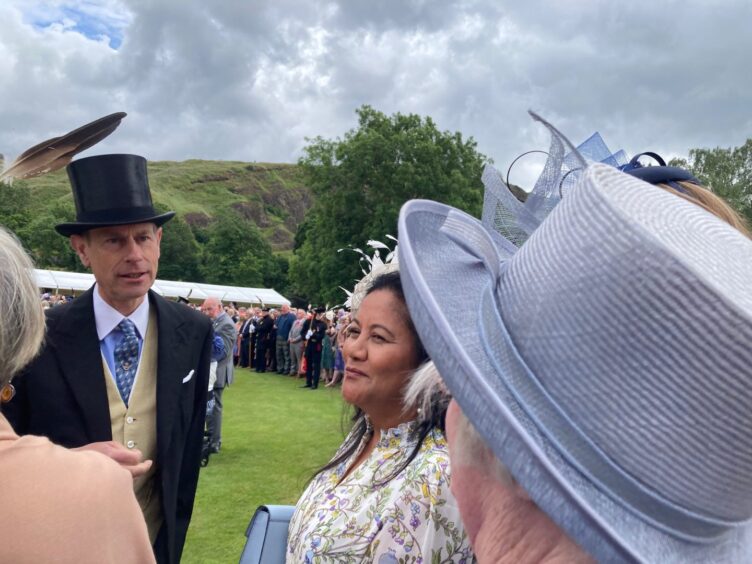 Duke of Edinburgh in top hat speaking to Perth Soroptimists at garden party