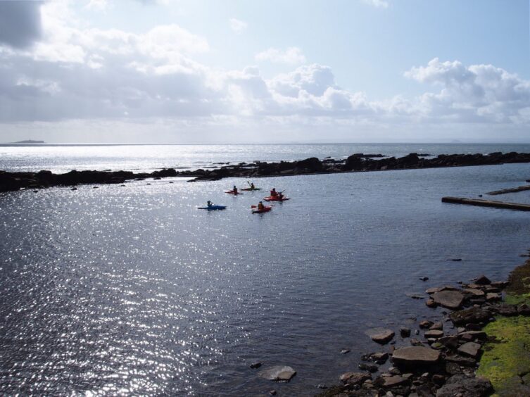 Image shows: A group of kayakers learning new skills at East Neuk Outdoors in Cellardyke. The watersports instructors teach new skills in the safe confines of the tidal pool.