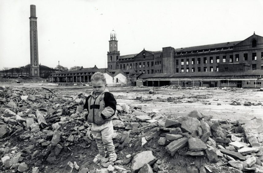 A small child standing on the rubble in 1989. 