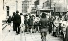 Queues on Panmure Street, Dundee, waiting for the bus in 1974.