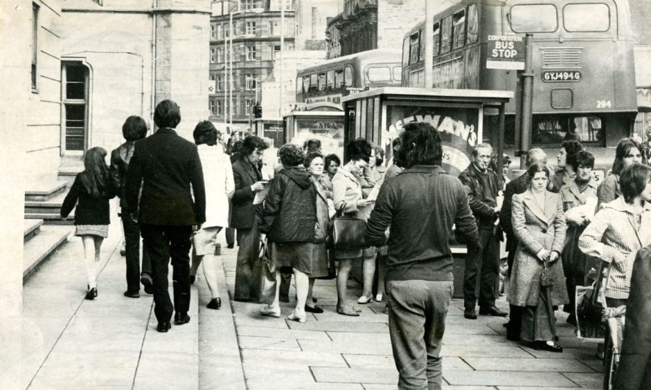 Queues on Panmure Street, Dundee, waiting for the bus in 1974.