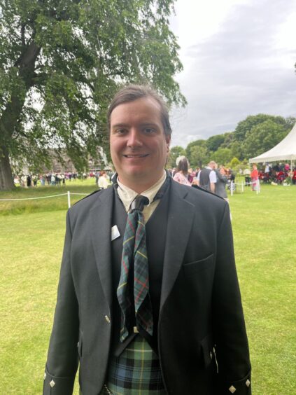 James Gardner in tartan at royal garden party Edinburgh