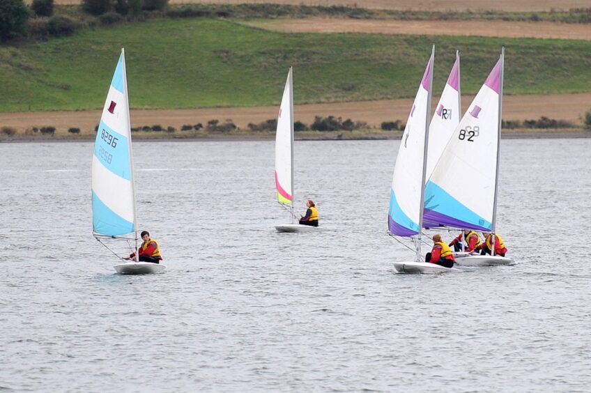 Image shows: a group of young people having a sailing lesson with Ancrum Outdoor Centre. There is a gourp o