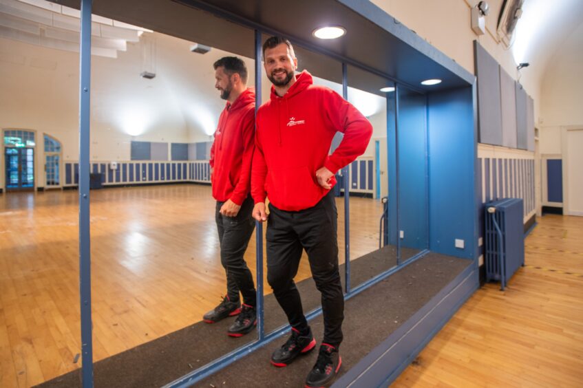 Kevin Cuthbert leaning against mirror in Rodney Pavilion gym