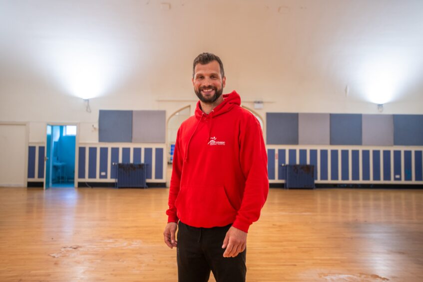 Kevin Cuthbert smiling inside Rodney Pavilion gym