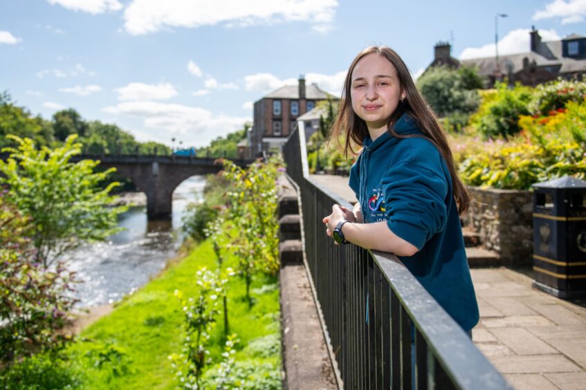 Joselyn Turner smiling beside river in Blairgowrie