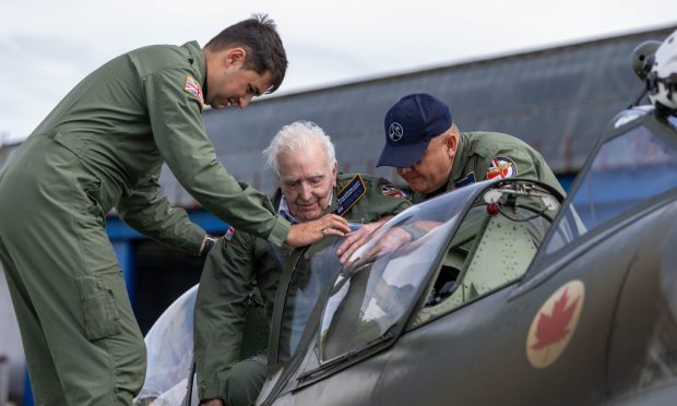 James being helped into the cockpit by Sam Jacob and Neil Hellier from Spitfires.com