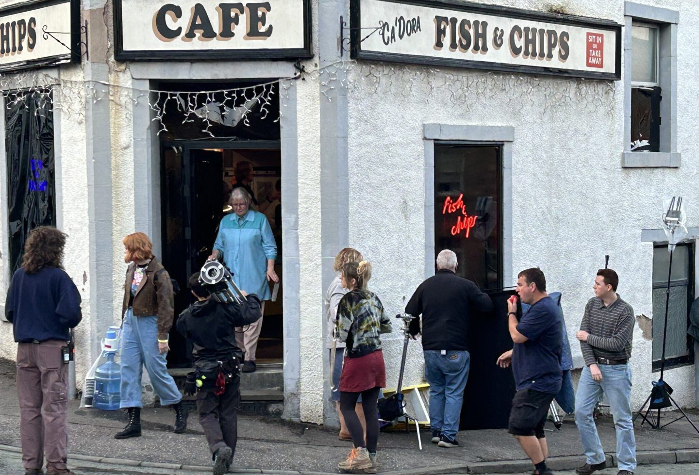 Actors leave the chip shop in Inverkeithing after filming a scene for the new Karen Pirie series.