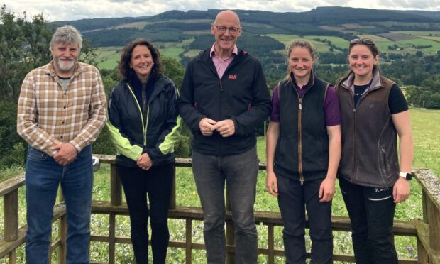 NFUS president Martin Kennedy, Rural Affairs Secretary Mairi Gougeon, First Minister John Swinney and Mr Kennedy's daughters, Yvonne and Katrina on their Aberfeldy hill farm.