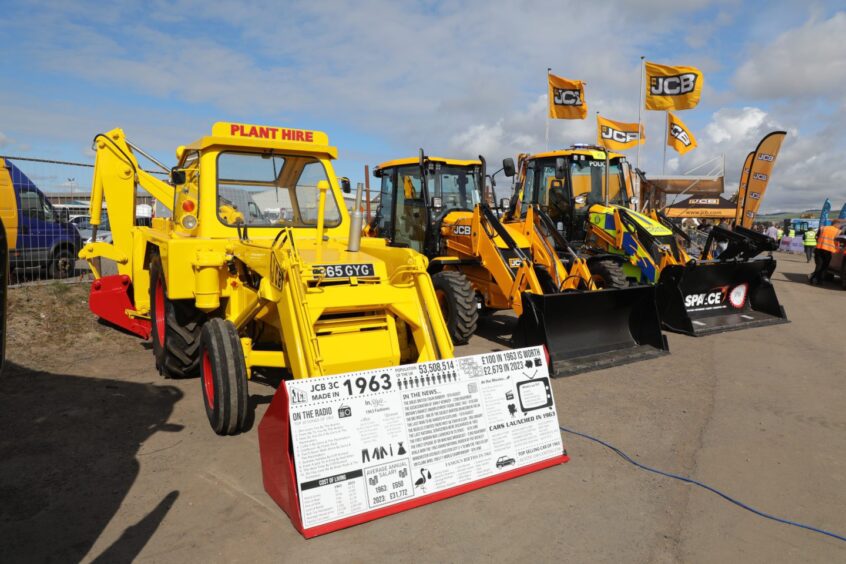 New JCB diggers next to vintage model