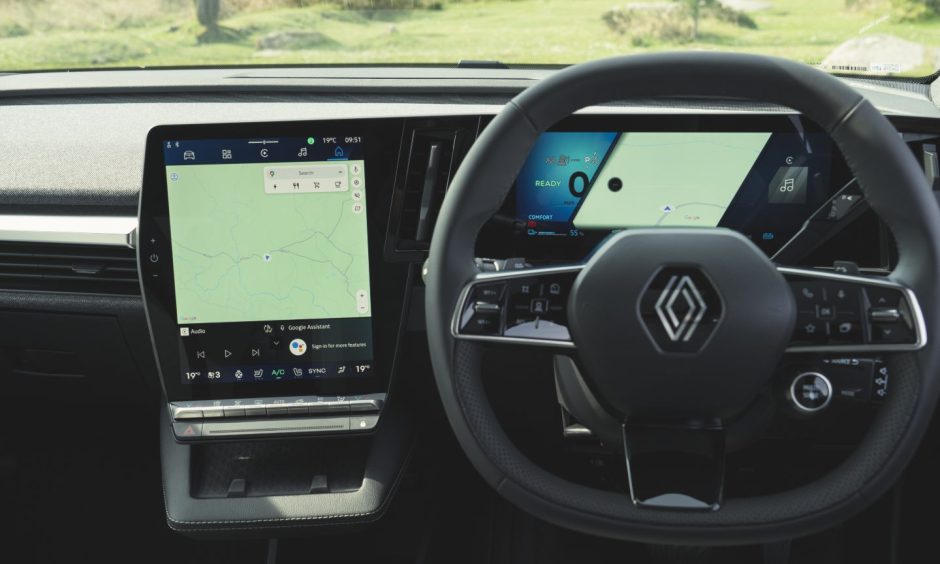 a close up showing the steering wheel and dashboard