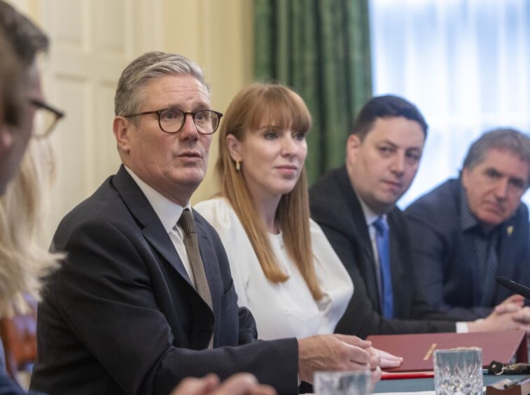 Angela Rayner, seated next to Prime Minister Sir Keir Starmer at Westminster meting table