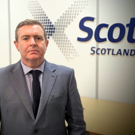 Phil Campbell in front of a ScotRail sign