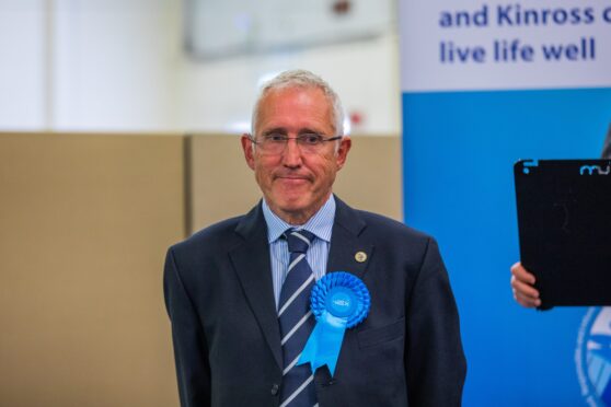 Crawford Reid in blue conservative rosette at election count