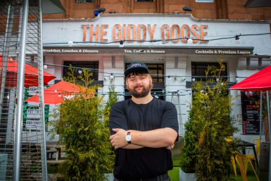 Kieran Gibson, arms folded outside Giddy Goose restaurant in Perth