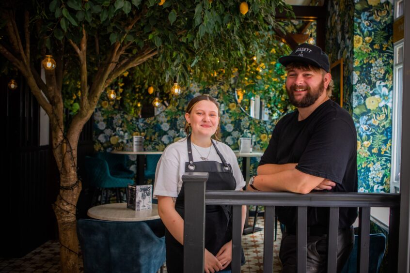 Niamh Barlow and Kieran Gibson smiling inside Giddy Goose restaurant in Perth