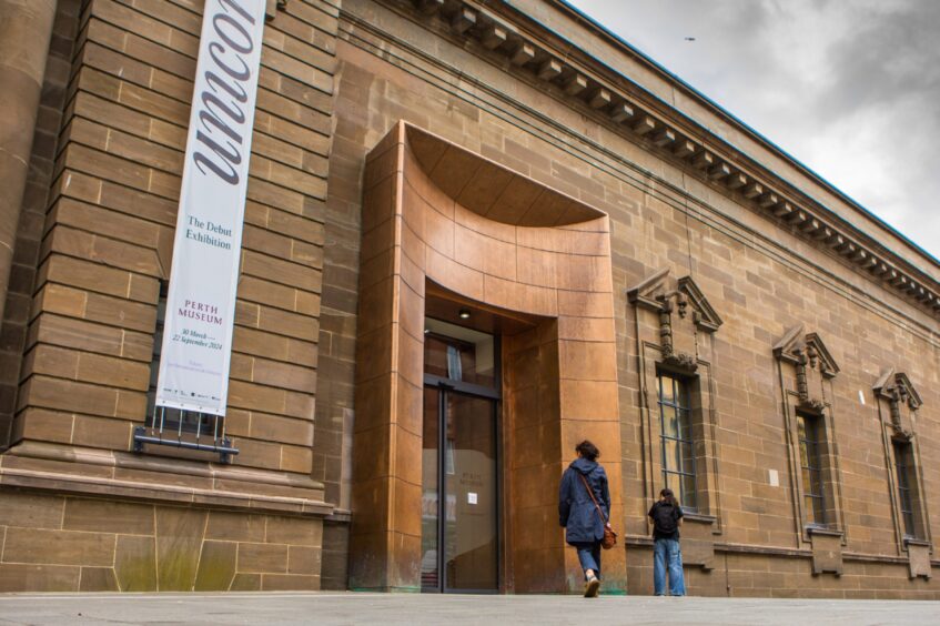 Woman walking into Perth Museum