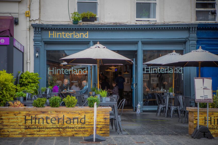 Hinterland coffee shop with customers seated at window tables inside