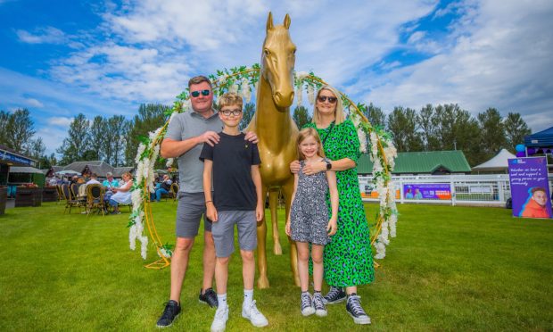 Ali and Lorraine with children Lois (aged 7) and Archie (aged 12)  getting ready to enjoy the races. Image: Steve MacDougall/DC Thomson