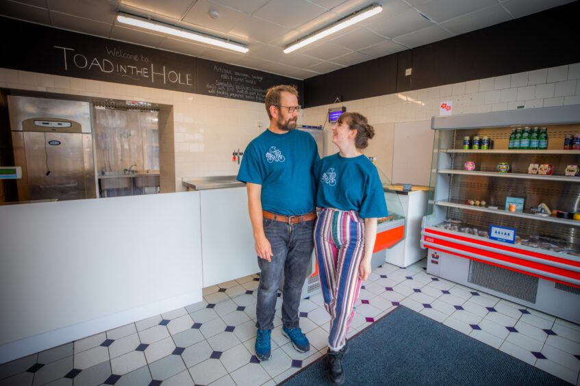 Aaron and Olivia Young smiling at each other inside Blairgowrie sausage shop