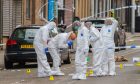Forensics officers at the scene of the attempted murder on Strathmartine Road, Dundee. Image: Steve MacDougall/DC Thomson