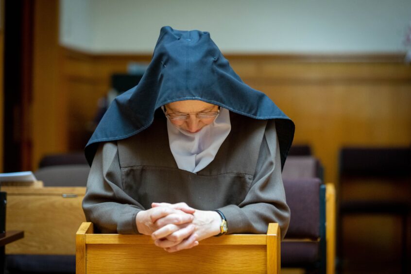 Sister Teresa at prayer in the choir.